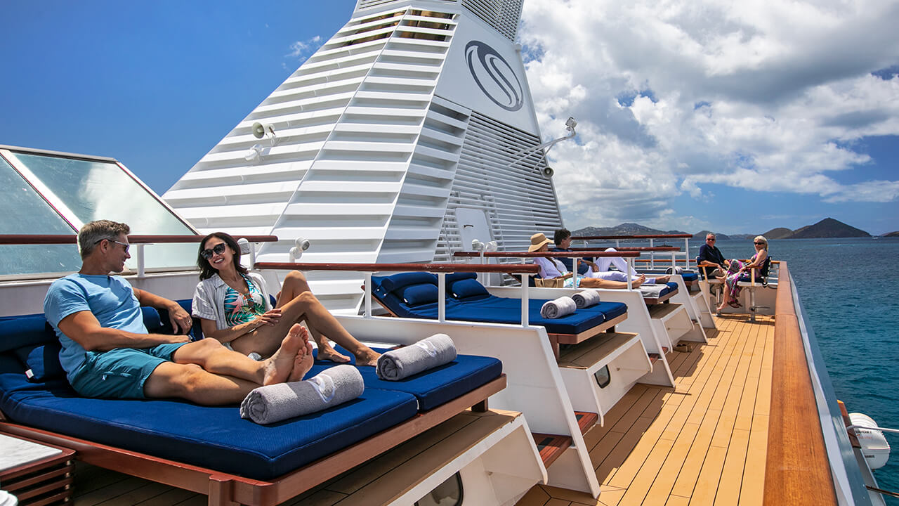 Couple lounging on Balinese beds aboard SeaDream